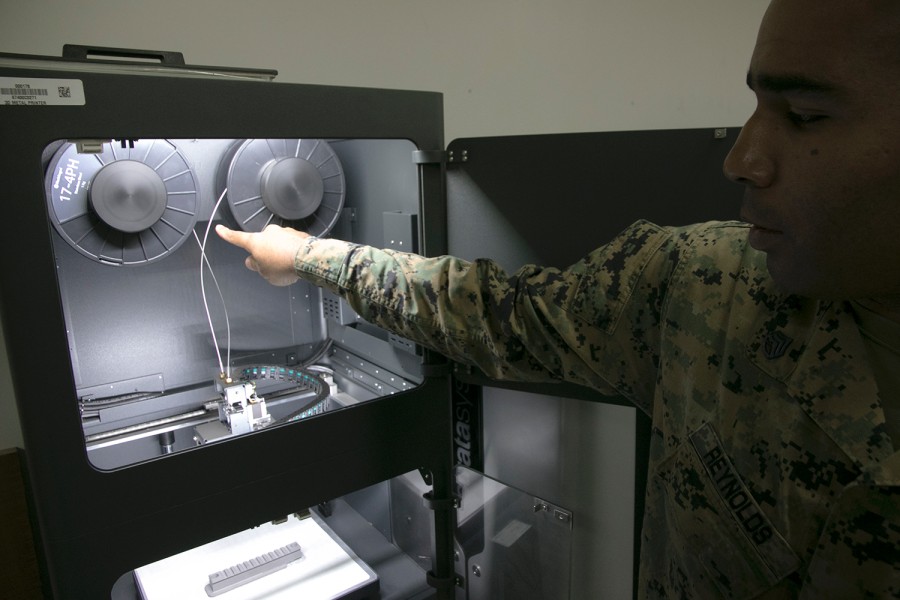 Marine Staff Sgt. Quincy Reynolds of the III Marine Expeditionary Force's 3rd Maintenance Battalion shows off the unit's new Markforged Metal X 3D printer at Camp Kinser, Okinawa, Jan. 16, 2020.MATTHEW M. BURKE/STARS AND STRIPES